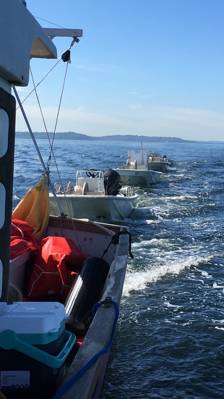 Support boats riding in tow during a boat delivery.