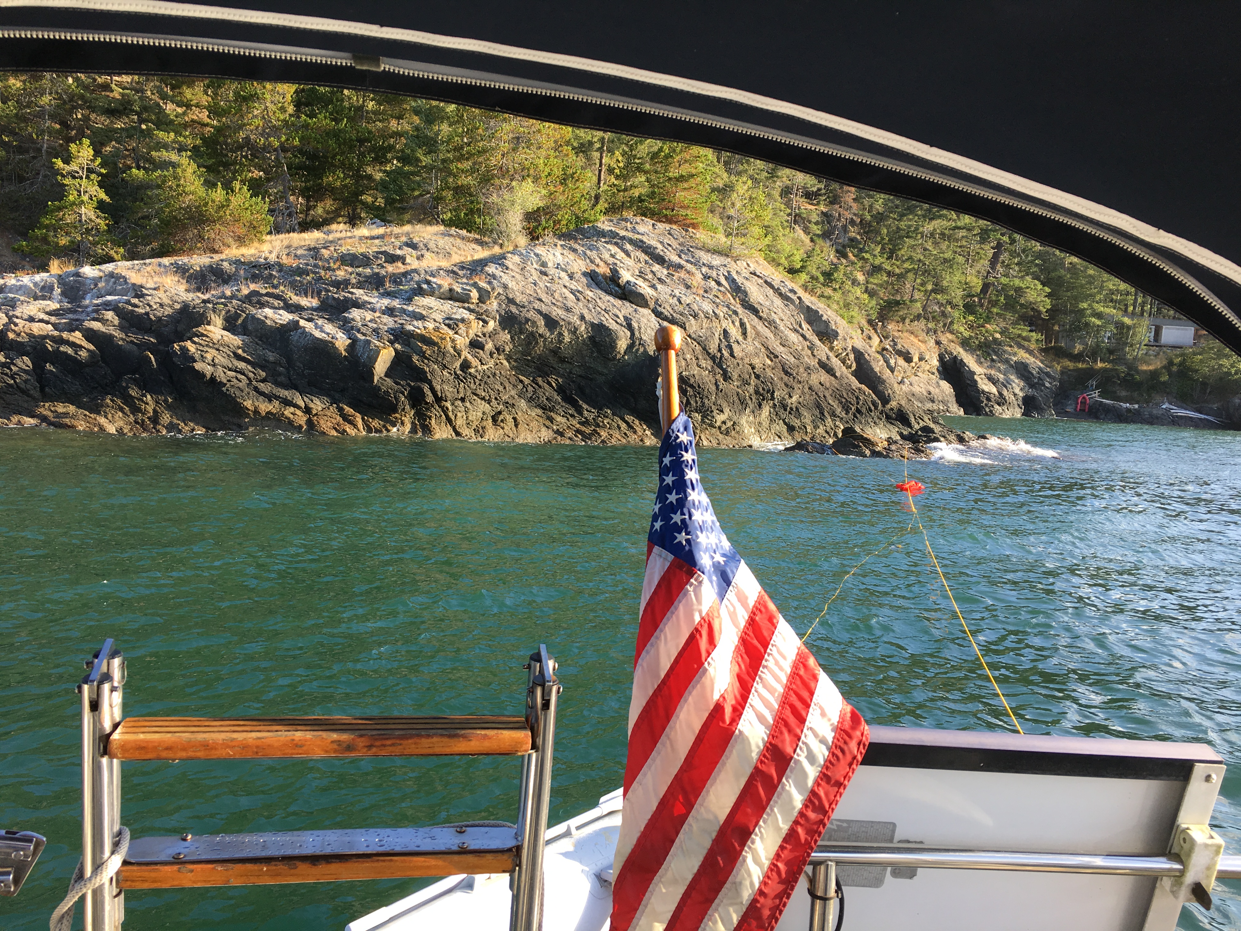 Rocky island shoreline viewed from the stern of the charter boat.