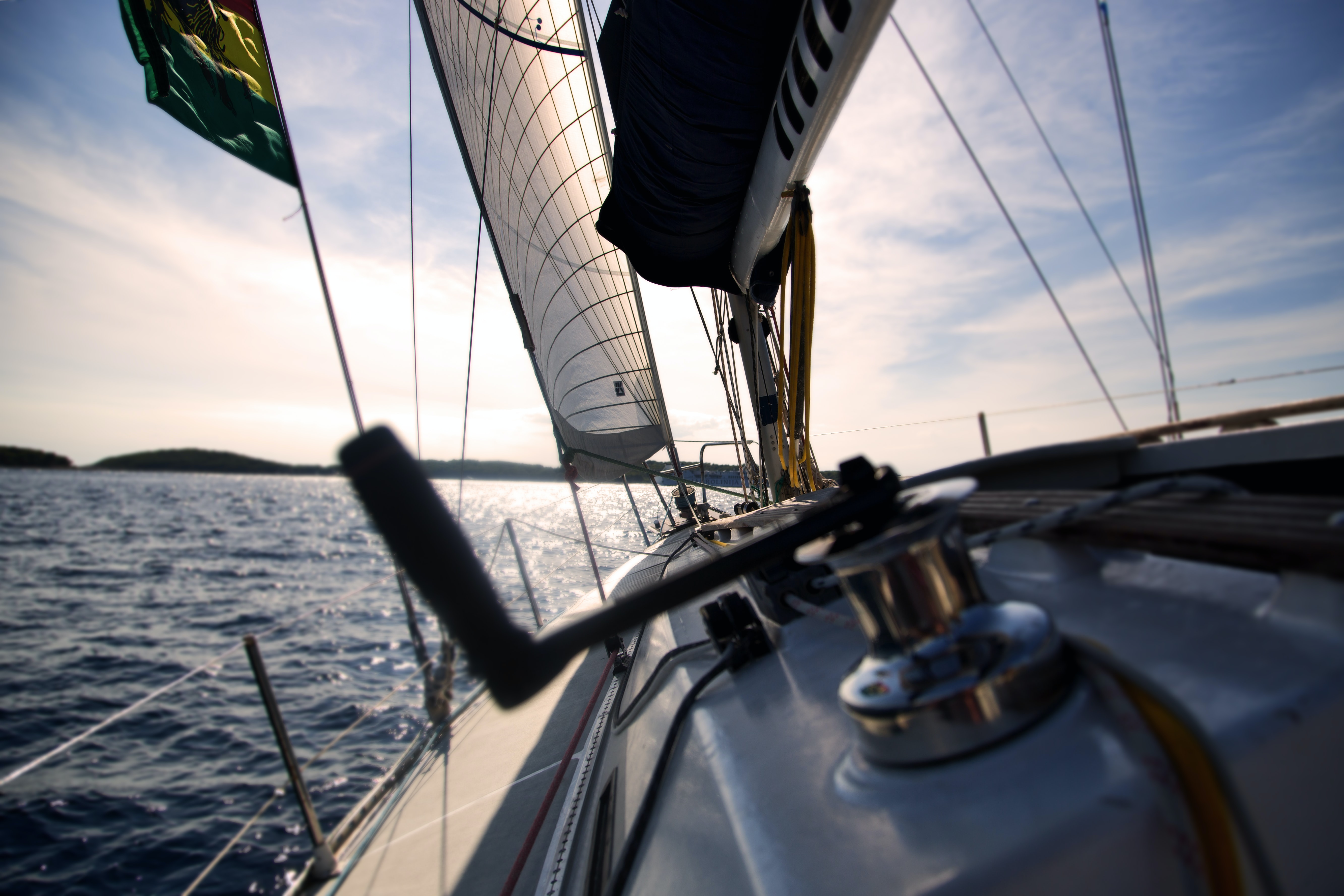 Sailboat underway on Puget Sound at golden hour.